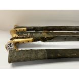 A pair of Islamic bone and coral set swords with s