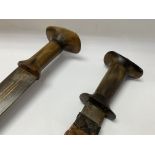 A pair of eastern horn handled swords, 1 sabre cur