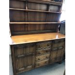 A oak dresser the raised back above four drawers f