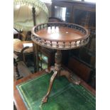A reproduction mahogany gallery table with a circu