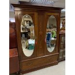 An Edwardian inlaid wardrobe with mirror doors. H.
