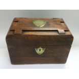 An oak box with brass shield cartouche, approx 23.