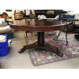 A round Victorian mahogany dining table with claw