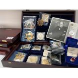 A large collection of cased commemorative coinage and reproduction Police badges. (D)