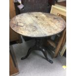 A circular oak tilt top table, approx diameter 74c
