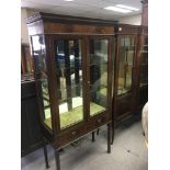 An inland mahogany display cabinet with glass shel