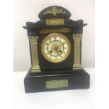A late Victorian black slate and marble mantel clock the enamel dial with the inscription Ferber &