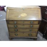 A George III bureau with decorative inlay and band