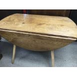 A Ercol drop leaf table with four matching open ar