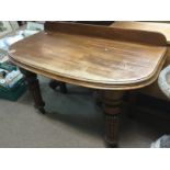 A mahogany dining table section converted to a car