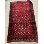 A Eastern hand knotted wool rug . 184 x 104cm