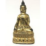 A gilt metal figure of a seated Buddha cast and wi