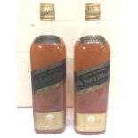 Two bottles of Johnnie Walker black label scotch w