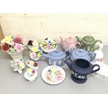 A collection of Coalport flowers and Wedgwood tea pots. Postage cat D