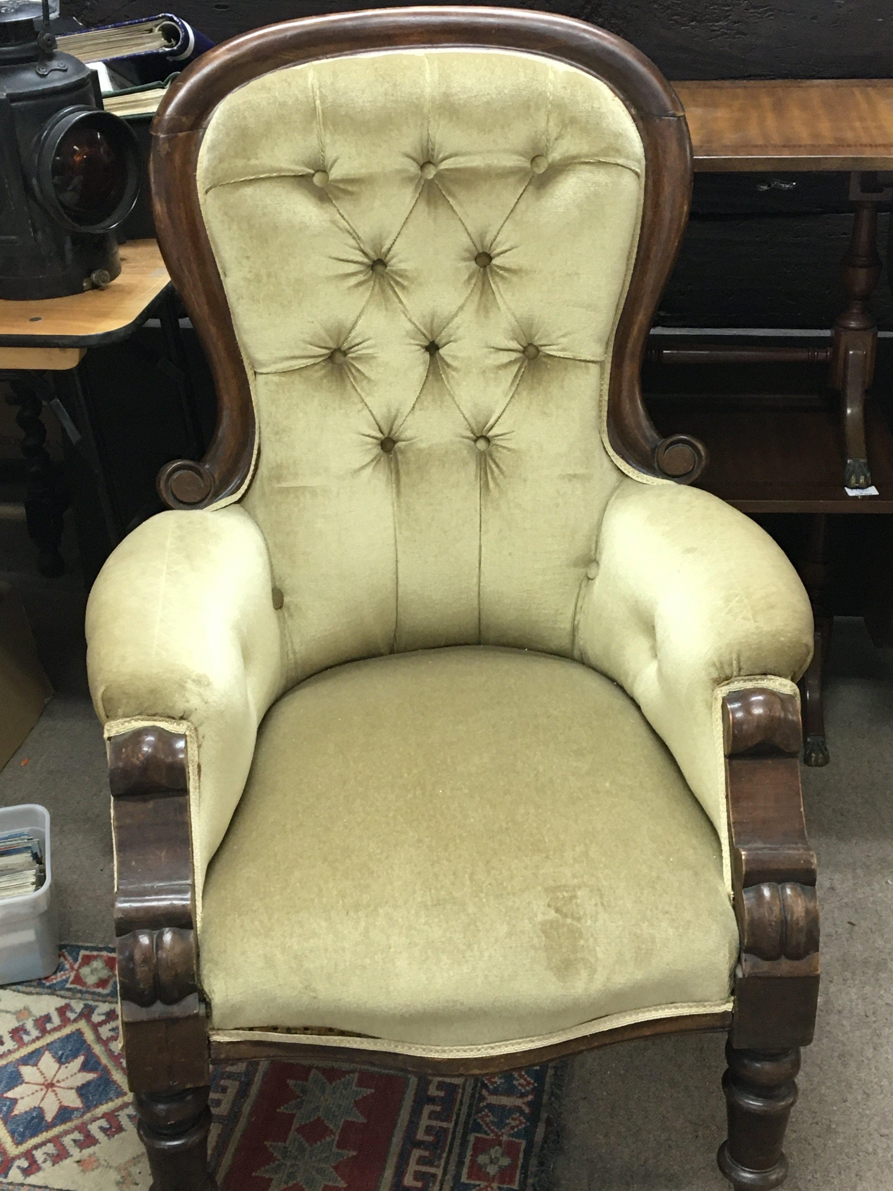 A Victorian arm chair with draylon button back uph