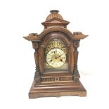 A Continental late 19th century walnut mantel clock. With key and pendulum Hight 48 cm