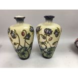 A pair of Moorcroft vases decorated with flowers a
