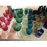 A collection of coloured drinking glasses.