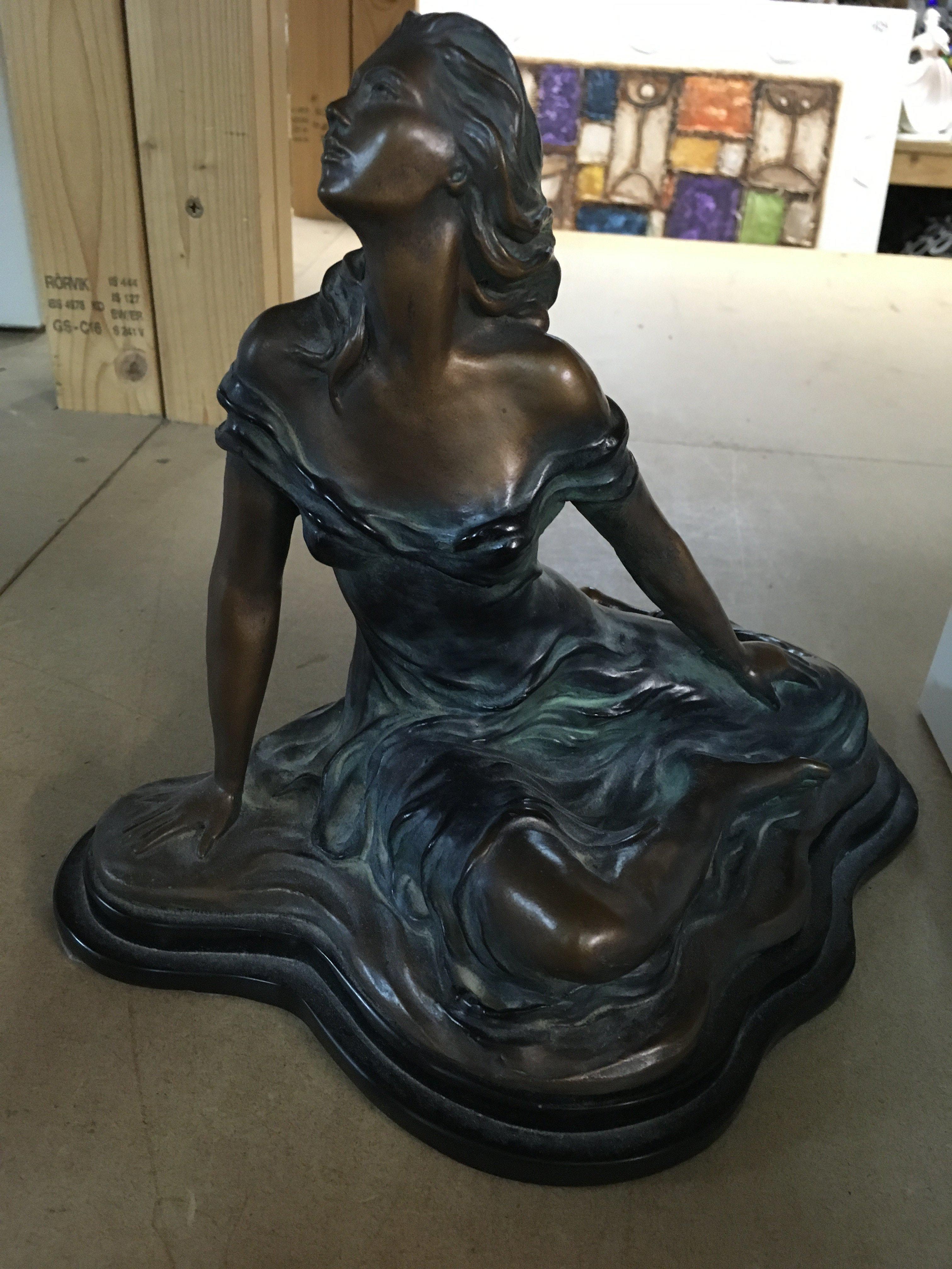 A Art nouveau style figure in the form of a seated maiden l
