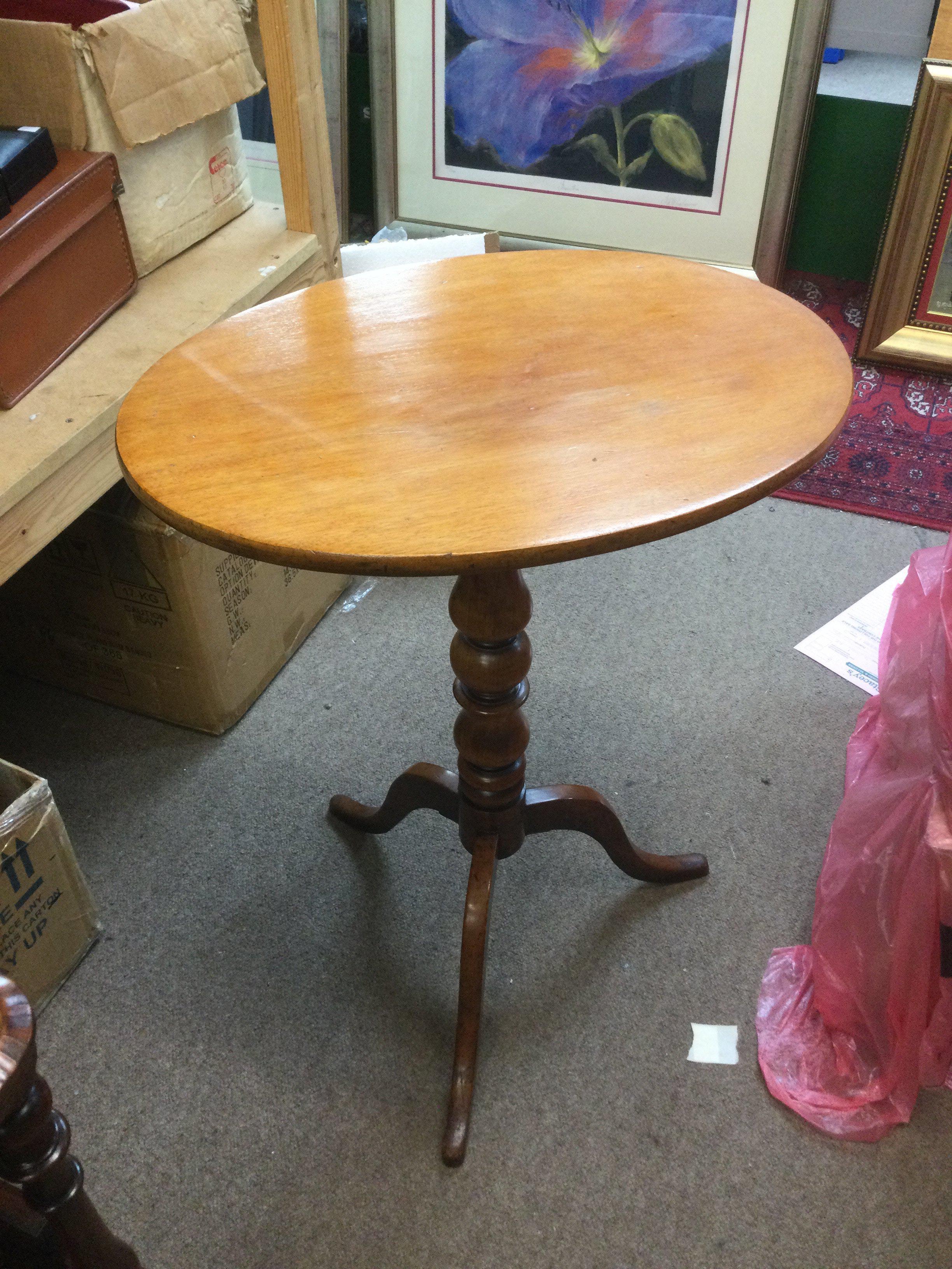 A mahogany occasional table with turned column sup