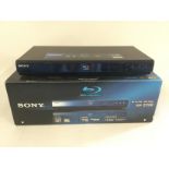 A boxed Sony blu-ray player and a boxed Toshiba 30