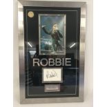 A framed and glazed presentation of Robbie William