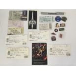 A collection of various tour programs, tickets, ba
