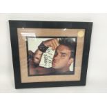 A framed and signed print of Robbie Williams with