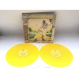A yellow vinyl double LP of 'Goodbye Yellow Brick