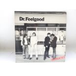 A copy of 'Malpractice' by Dr Feelgood, signed by