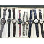 A box with 18 various Swatch watches, most seen wo