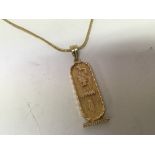 A high grade gold Egyptian pendent and chain weigh