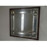 A large silver mounted wall mirror of rectangular