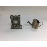 A small 925 miniature clock and watering can.