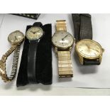 A collection of four watches including Tissot and