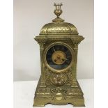 A Victorian brass mantel clock with a dome top and