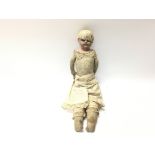 An early Victorian leather and composition doll. A