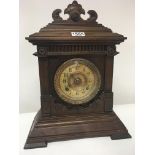 A Continental carved walnut mantel clock seen work