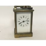 A brass case carriage clock the enamel dial with R