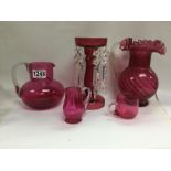 A cranberry jug and other cranberry pieces.