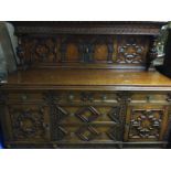 A oak sideboard the raised carved back above five