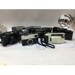 Ten small compact automatic film cameras.