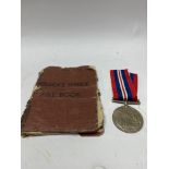 A WWII medal with soldiers service book.