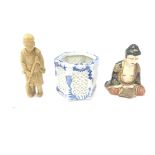 Two oriental figures and a blue and white pot.