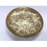 A Satsuma ware dish depicting various figures and