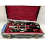 A cased Boosey & Hawkes Regent Clarinet with sheet