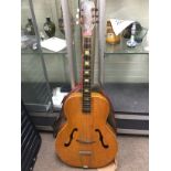 A vintage hollow bodied guitar, possibly East Euro