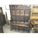 A Victorian carved oak settle. 130cm wide 195 tall