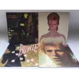 Three David Bowie LPs and one 12 inch single compr