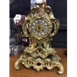 A Victorian gilt mantel clock the circular dial wi